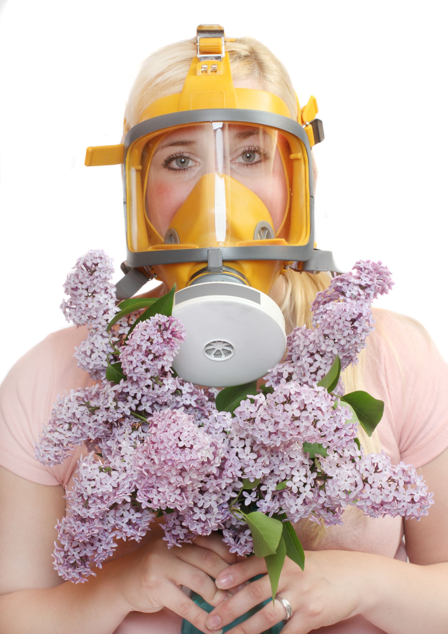 woman wearing gas mask holding purple flowers