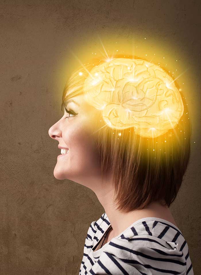profile of smiling woman with gold brain graphic on head